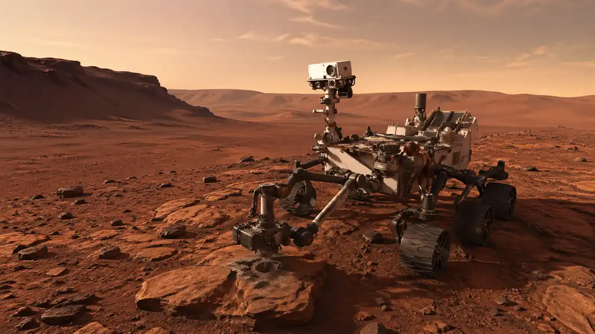 Curiosity keşif aracının Mars yüzeyinde organik molekülleri analiz ettiği anın temsili görseli